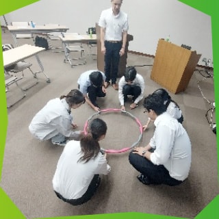 リングの形状のものをみんなで囲む様子